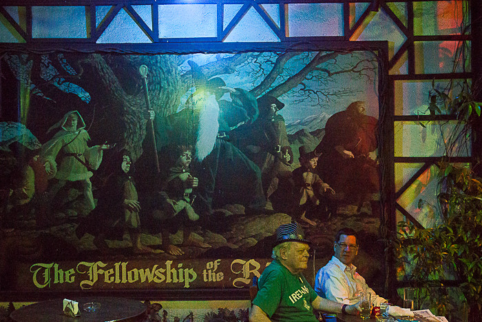 Jim, the owner of Hobbit House, in front of a Fellowship of the Ring artwork.